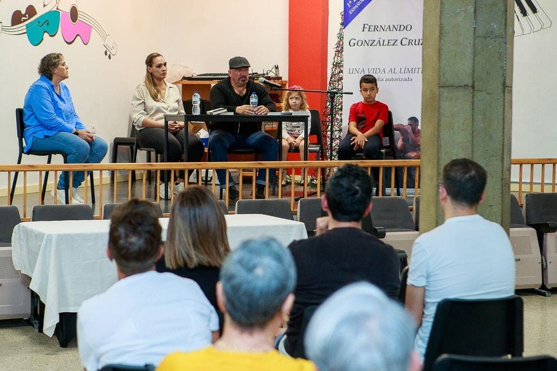 Fernando González Cruz en la mesa del acto de la Sociedad El Tabaibal, con el cartel de «Una vida al límite» al fondo